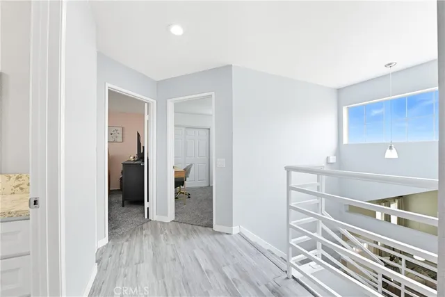 a view of a hallway with wooden floor