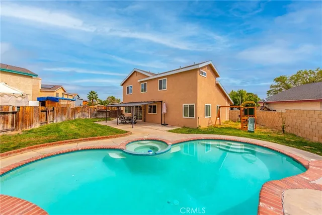 a front view of a house with swimming pool having outdoor seating