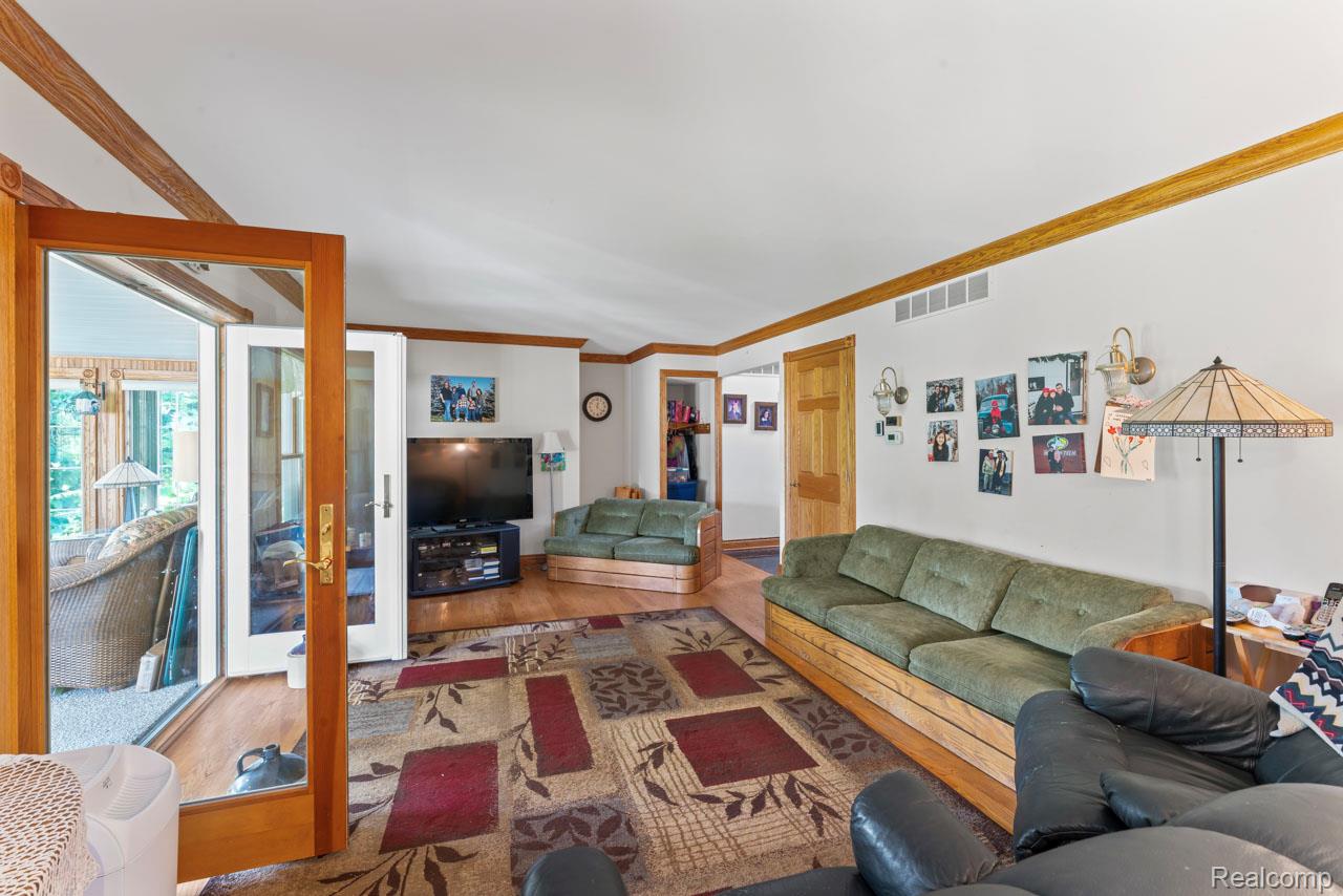 1591 Baldwin Road Lapeer, MI 48446 - Photo 4 of 46 Living area with wood finished floors and crown molding