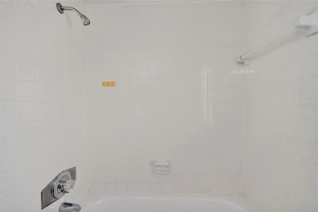 a view of an empty room with window and closet area