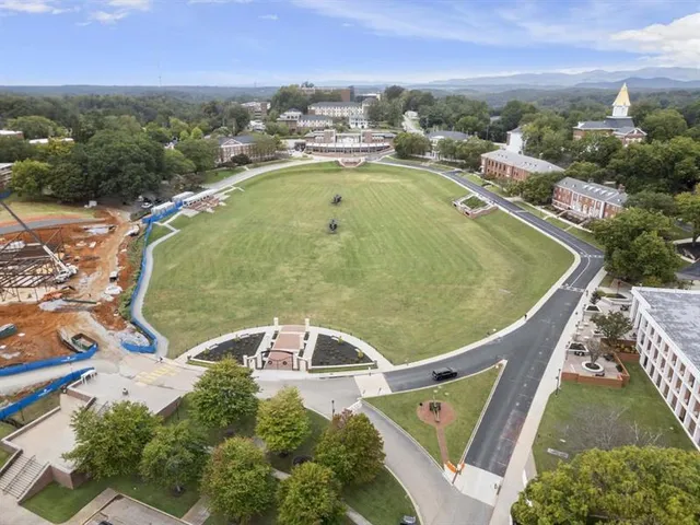 an aerial view of a house with a garden and lake view