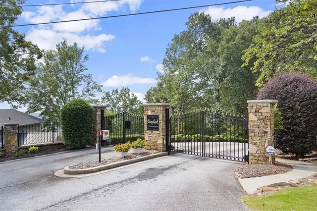 a view of a house with a tree in front of it