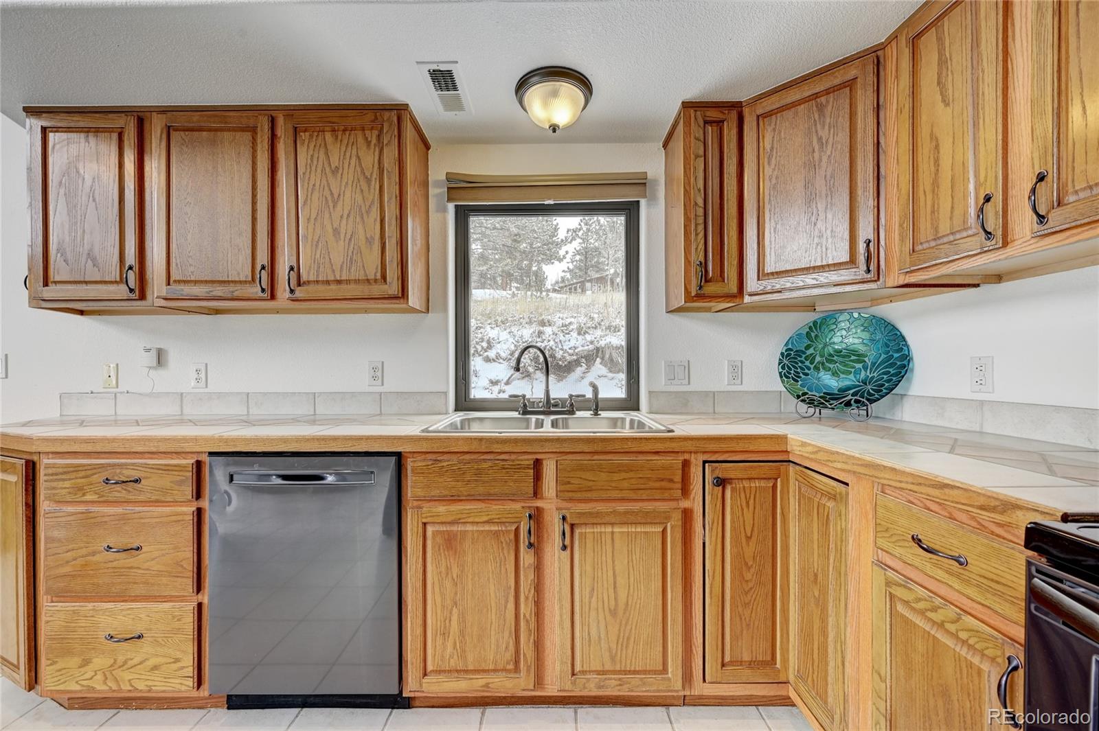 311 North Random Road Bailey, CO 80421 - Photo 17 of 40 a kitchen with cabinets appliances and a sink