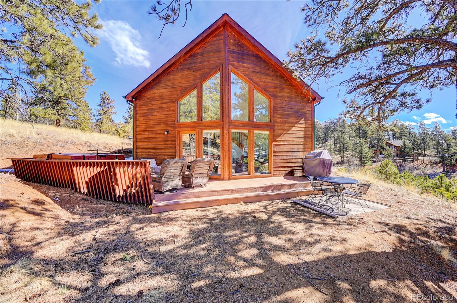 311 North Random Road Bailey, CO 80421 - Photo 5 of 40 a view of backyard with deck and outdoor seating
