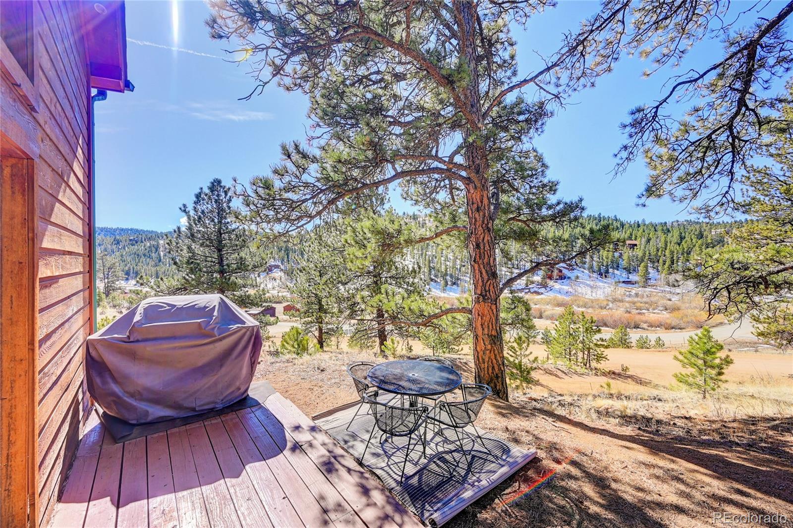 311 North Random Road Bailey, CO 80421 - Photo 7 of 40 a view of a chairs and table on the wooden floor
