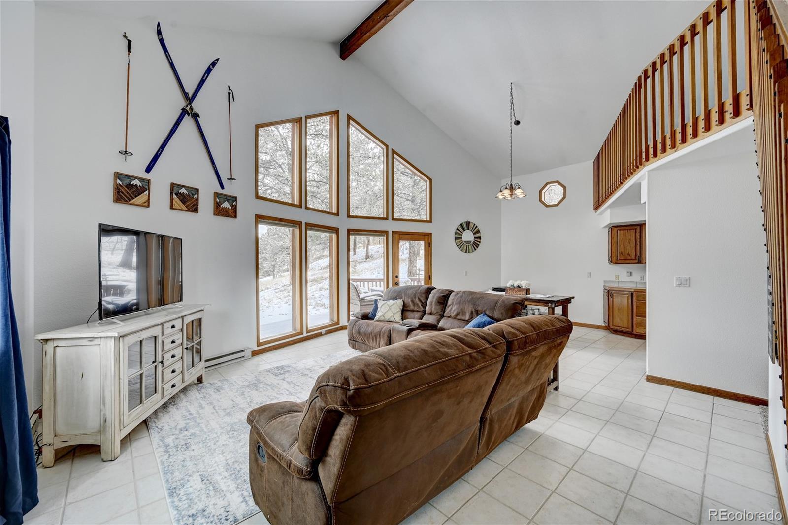 311 North Random Road Bailey, CO 80421 - Photo 10 of 40 a living room with furniture a flat screen tv and a window