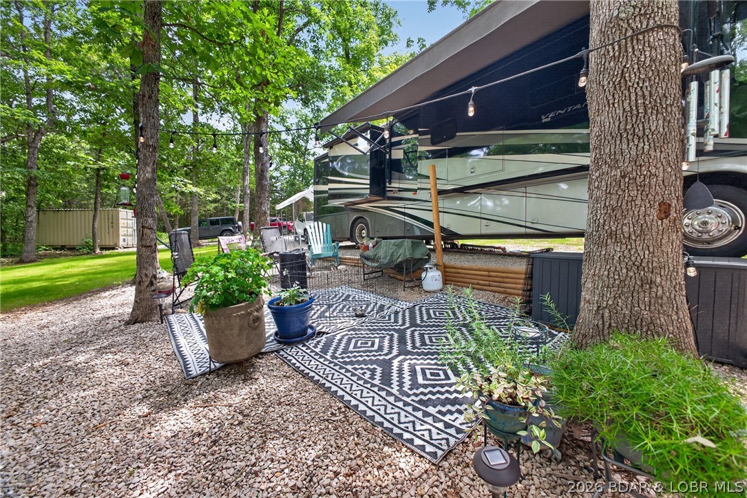 25145 State Route West Barnett, MO 65011 - Photo 41 of 58 String lit tree, shaded lounge area, nicely lands