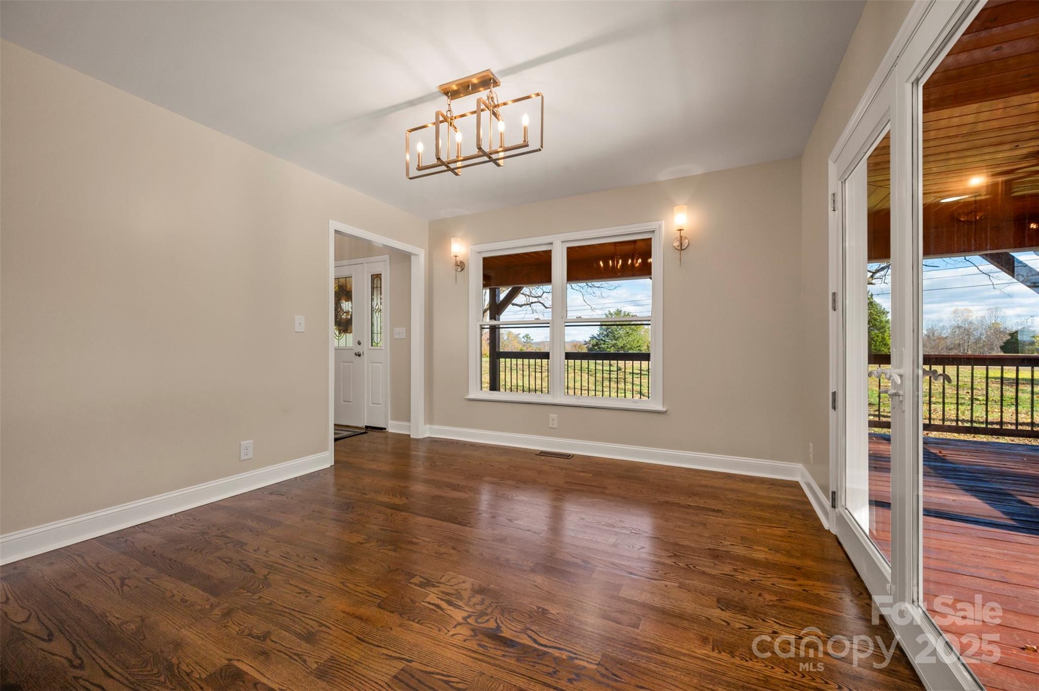 1121 Cove Road Rutherfordton, NC 28139 - Photo 12 of 41 an empty room with wooden floor and windows