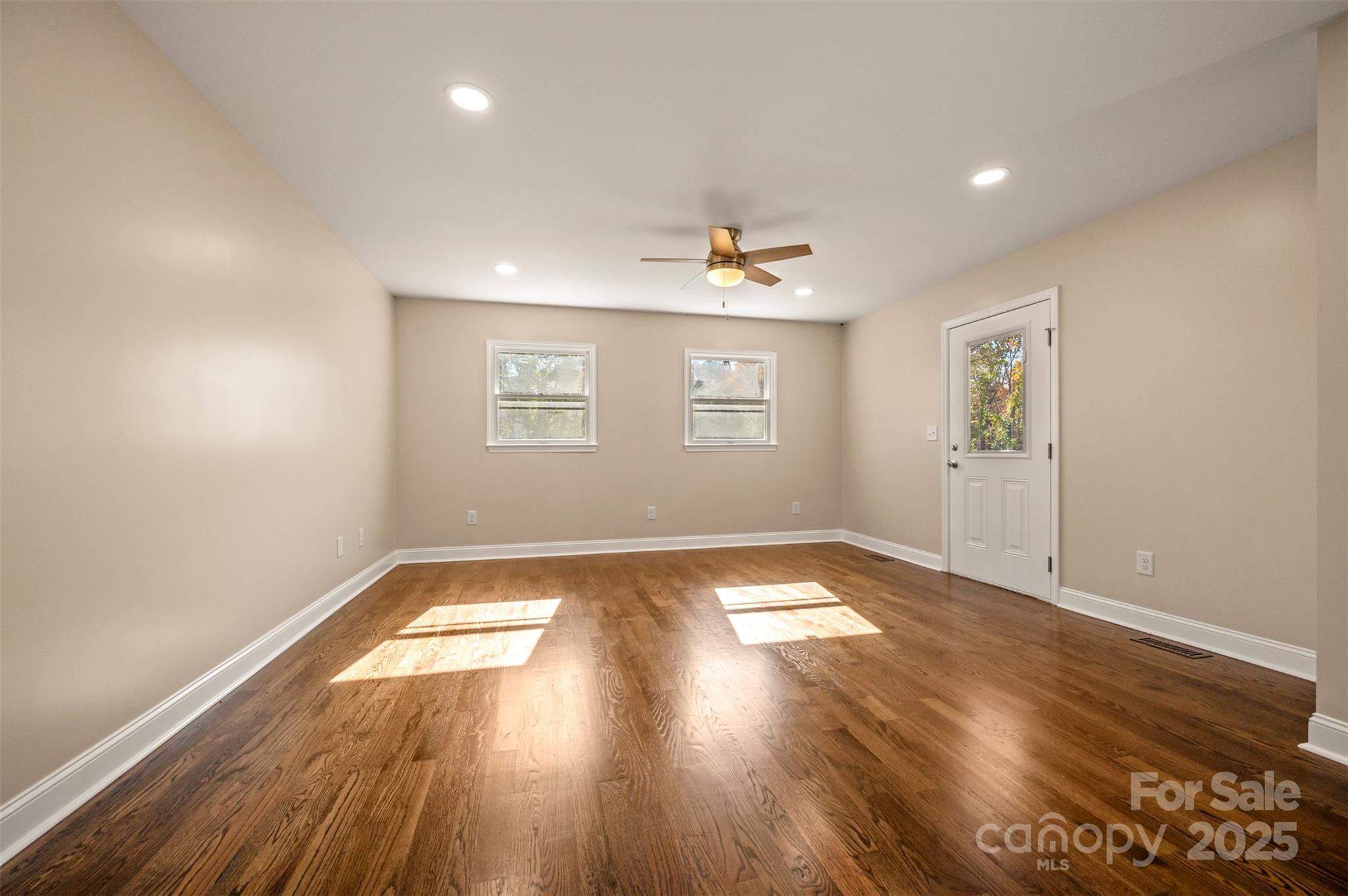 1121 Cove Road Rutherfordton, NC 28139 - Photo 13 of 41 an empty room with wooden floor and windows