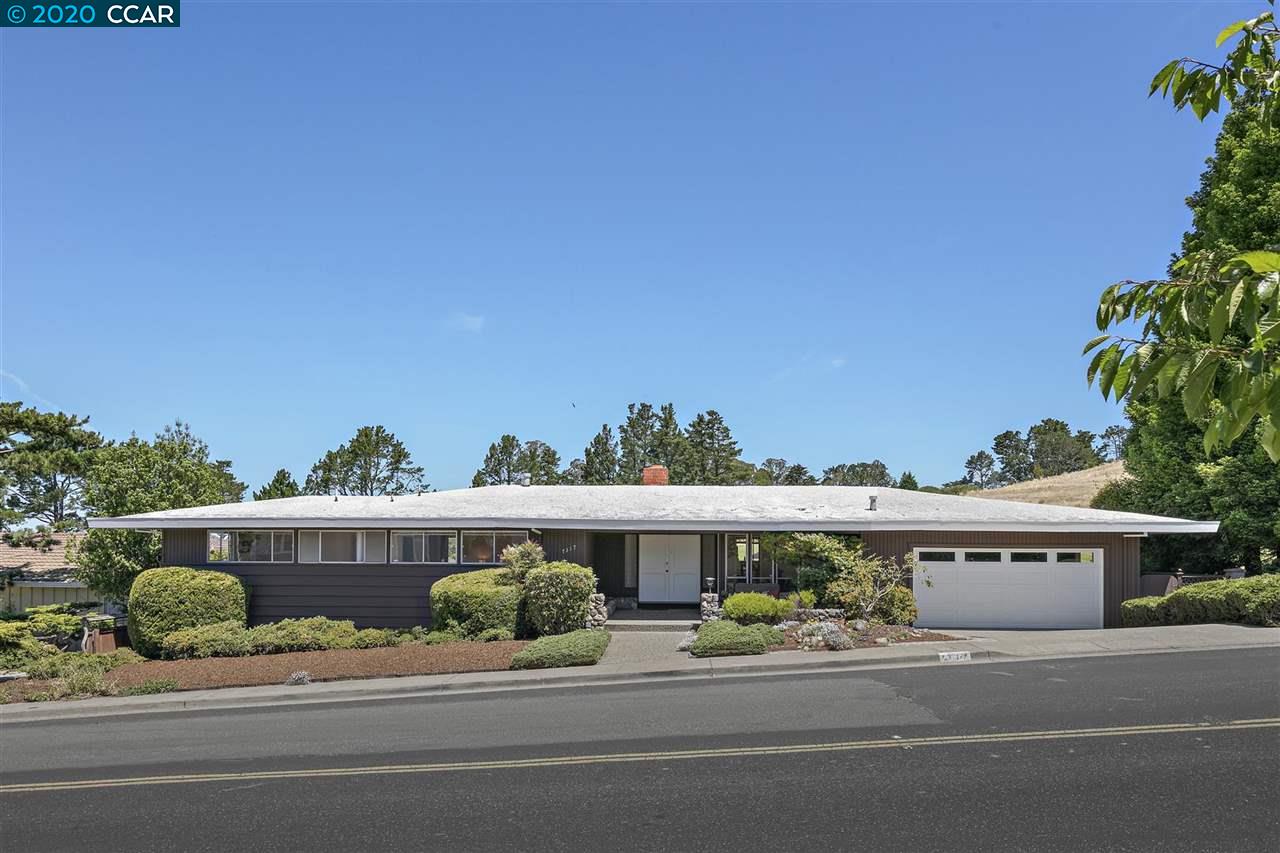 a front view of a house with a yard and outdoor seating