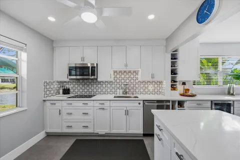 a kitchen that has a lot of cabinets in it and appliances