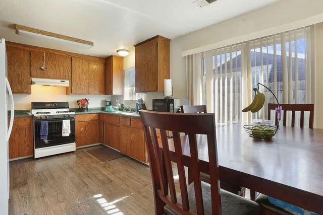 a kitchen with stainless steel appliances granite countertop a stove a sink and a refrigerator