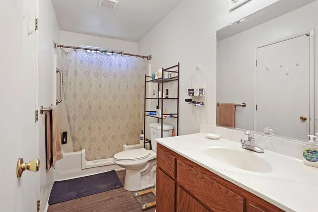 a bathroom with a sink toilet a mirror and shower