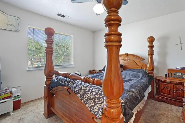 a bedroom with two beds and a window