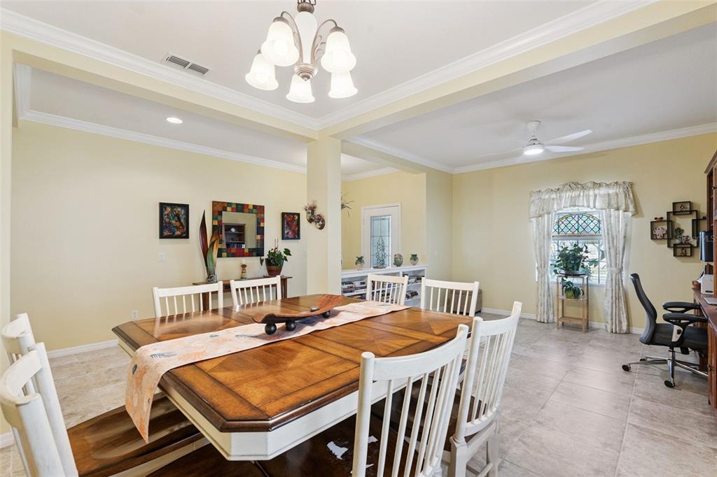 12332 Hammock Pointe Circle Clermont, FL 34711 - Photo 11 of 39 a dining room with furniture a rug and wooden floor