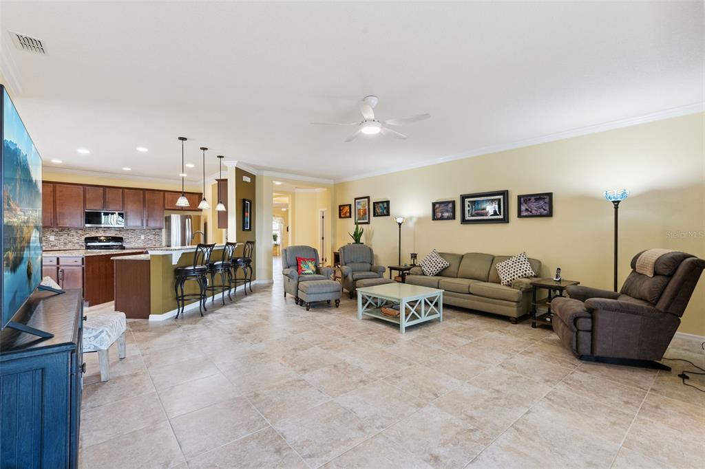 12332 Hammock Pointe Circle Clermont, FL 34711 - Photo 17 of 39 a living room with furniture and kitchen view