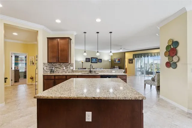 a kitchen with stainless steel appliances granite countertop a sink a stove and a refrigerator