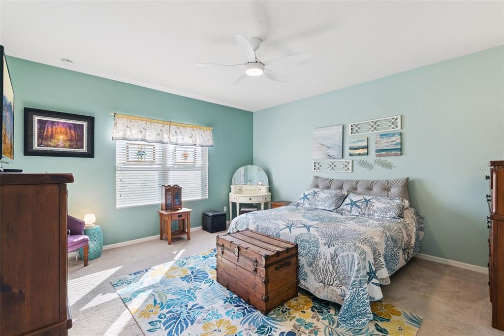 12332 Hammock Pointe Circle Clermont, FL 34711 - Photo 25 of 39 a bedroom with a bed table and two window