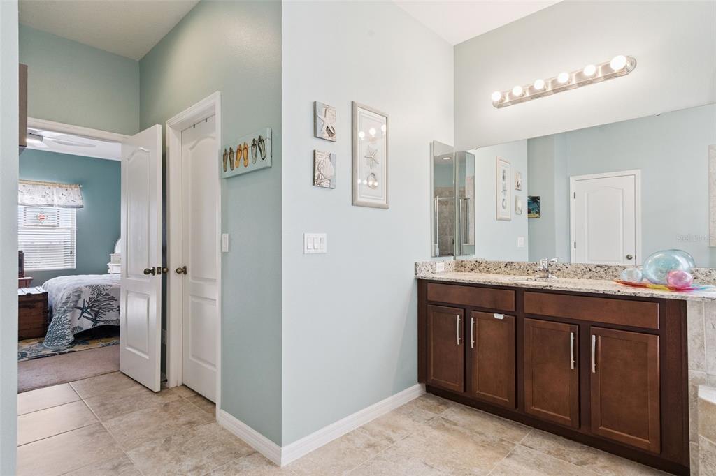 12332 Hammock Pointe Circle Clermont, FL 34711 - Photo 27 of 39 a spacious bathroom with a granite countertop sink and a mirror