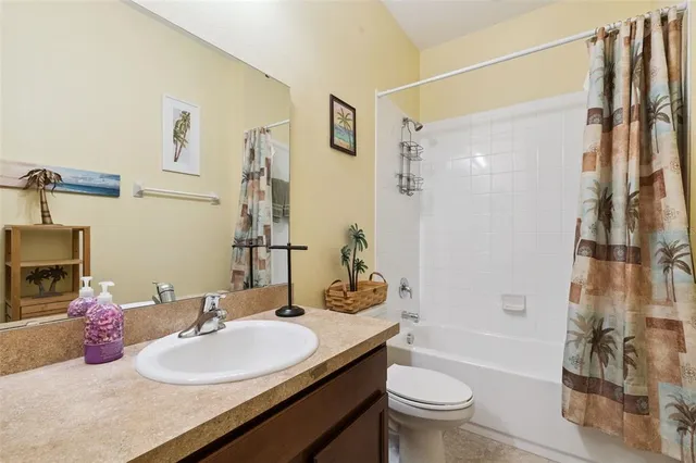 a bathroom with a granite countertop sink a mirror and a shower