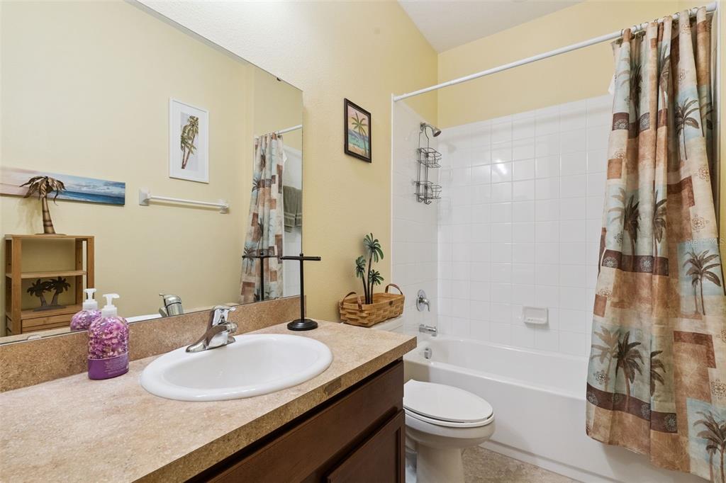 12332 Hammock Pointe Circle Clermont, FL 34711 - Photo 29 of 39 a bathroom with a granite countertop sink toilet and shower