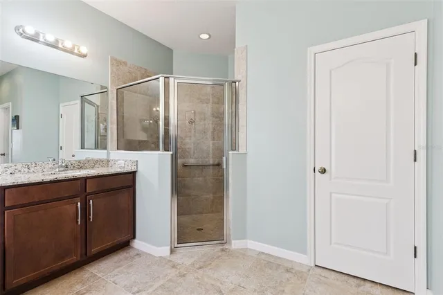 a spacious bathroom with a granite countertop tub sink and mirror