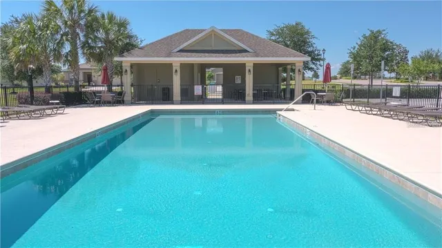 a view of swimming pool with outdoor seating and plants
