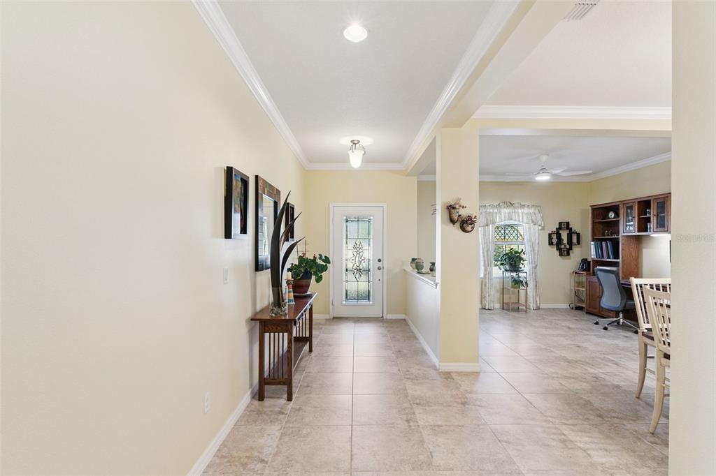 12332 Hammock Pointe Circle Clermont, FL 34711 - Photo 5 of 39 a view of a hallway with workspace and livingroom with furniture