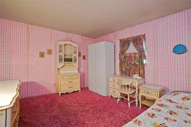 a bedroom with a bed and a chair in it