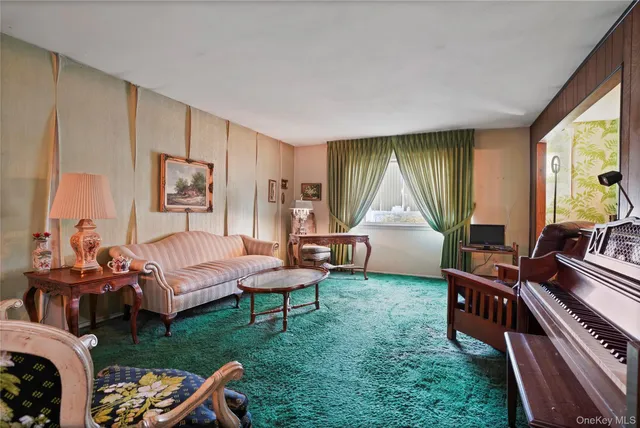 a bedroom with furniture and a large window