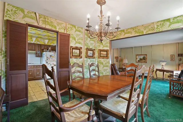a dining room with furniture a chandelier and window