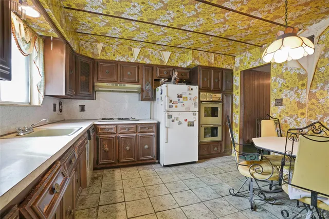 a kitchen with a sink a stove and a refrigerator