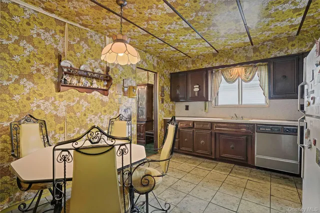 a kitchen with cabinets a sink appliances and a counter top