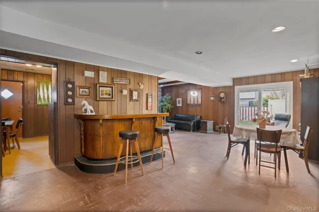 a dining room with furniture and a floor to ceiling window