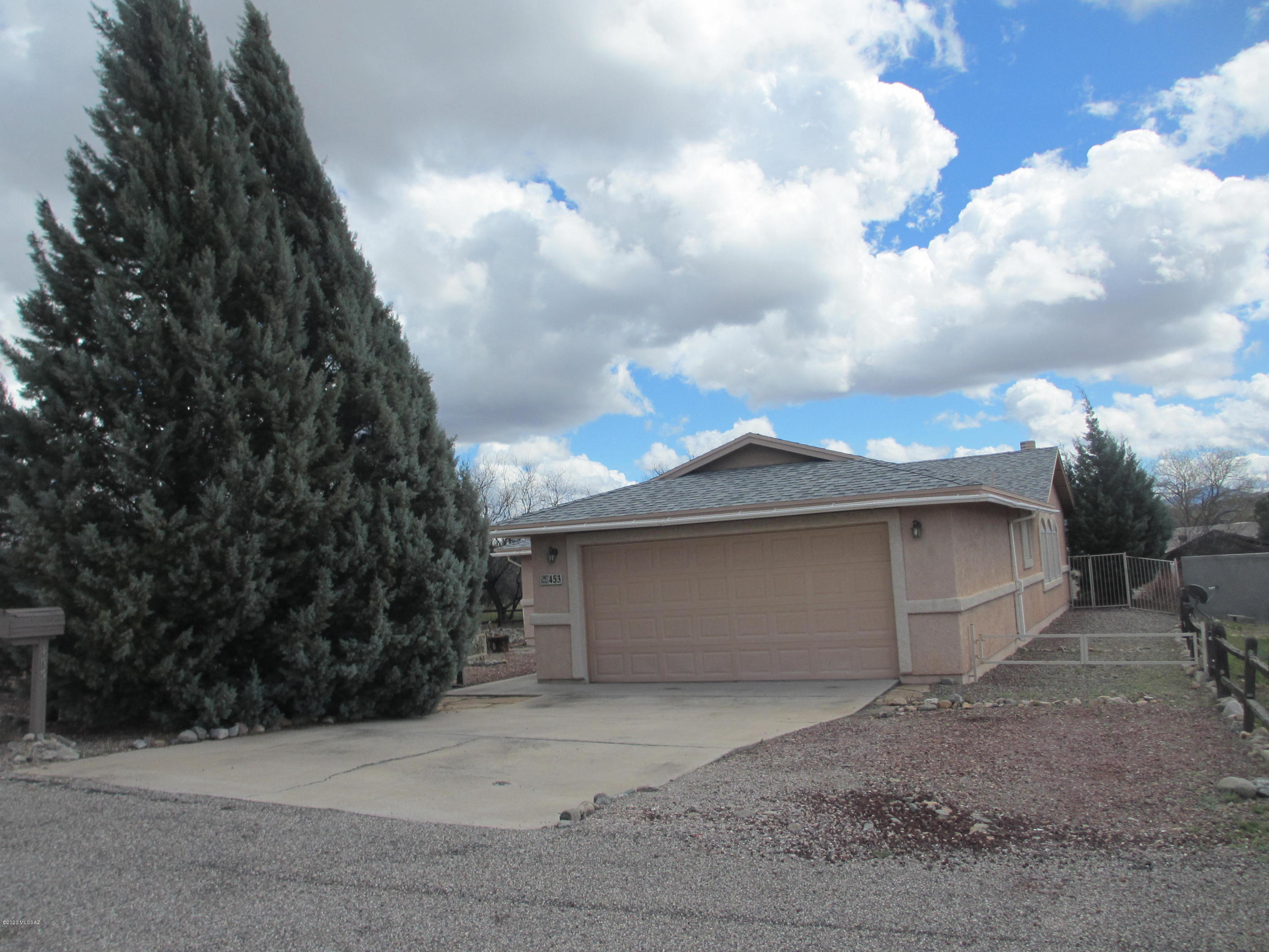 453 Chalet Court Rio Rico, AZ 85648 - Photo 24 of 26 a view of a house with a yard and garage