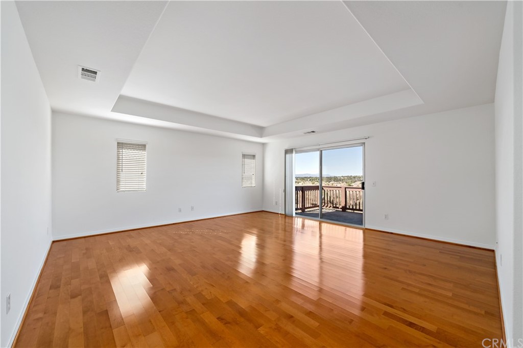 33782 Channel Street Temecula, CA 92592 - Photo 12 of 44 a view of empty room with wooden floor and fan