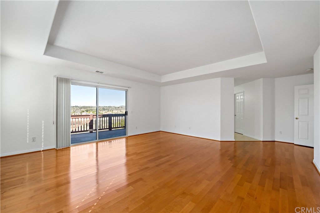 33782 Channel Street Temecula, CA 92592 - Photo 13 of 44 a view of an empty room with wooden floor and a window