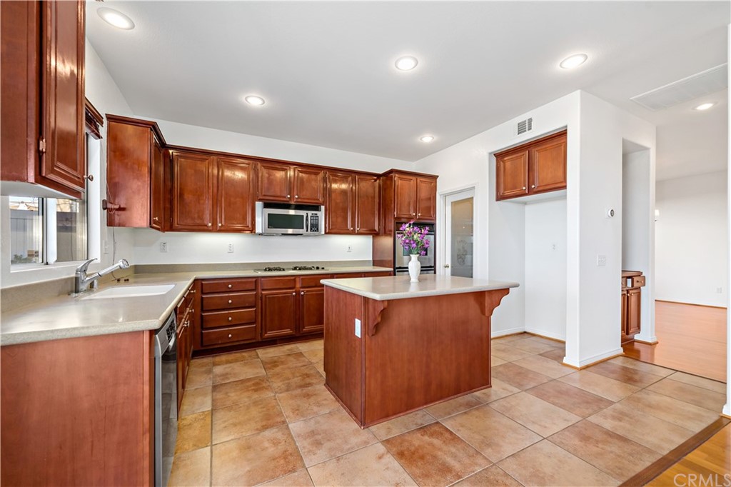 33782 Channel Street Temecula, CA 92592 - Photo 2 of 44 a kitchen with stainless steel appliances granite countertop a stove a sink and a refrigerator