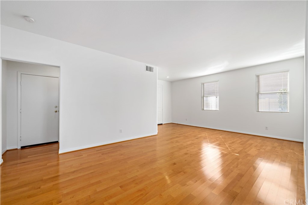 33782 Channel Street Temecula, CA 92592 - Photo 25 of 44 a view of an empty room with wooden floor and a window