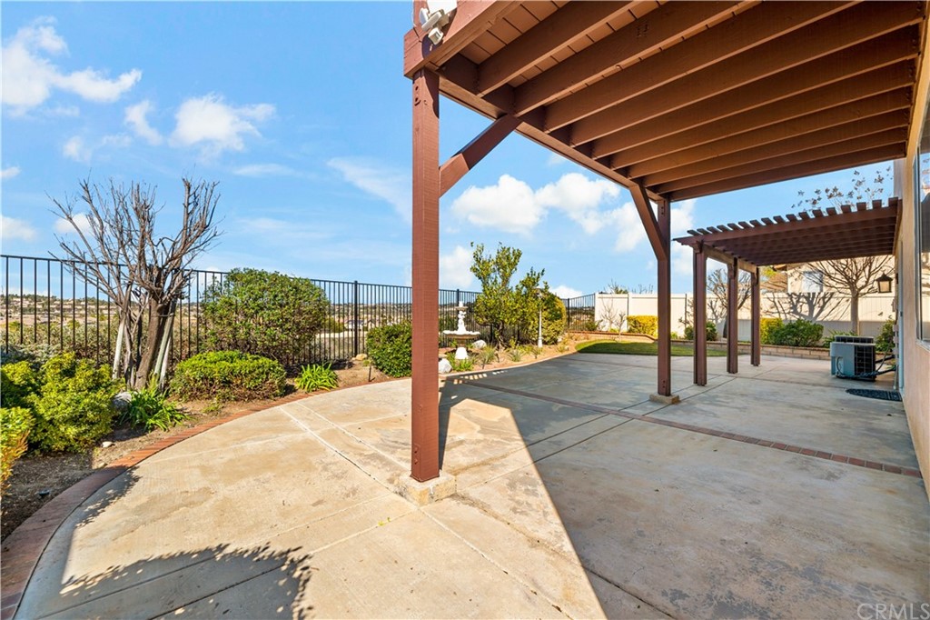 33782 Channel Street Temecula, CA 92592 - Photo 35 of 44 a patio with table and chairs and potted plants