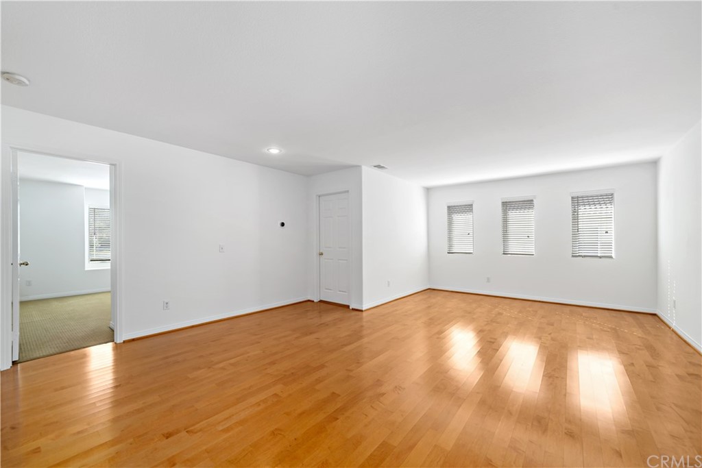 33782 Channel Street Temecula, CA 92592 - Photo 10 of 44 a view of empty room with wooden floor and fan
