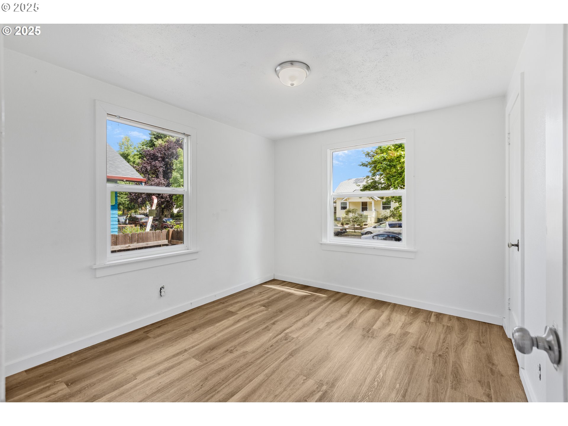 1391 West 5th Avenue Eugene, OR 97402 - Photo 13 of 35 a view of an empty room with window and wooden floor