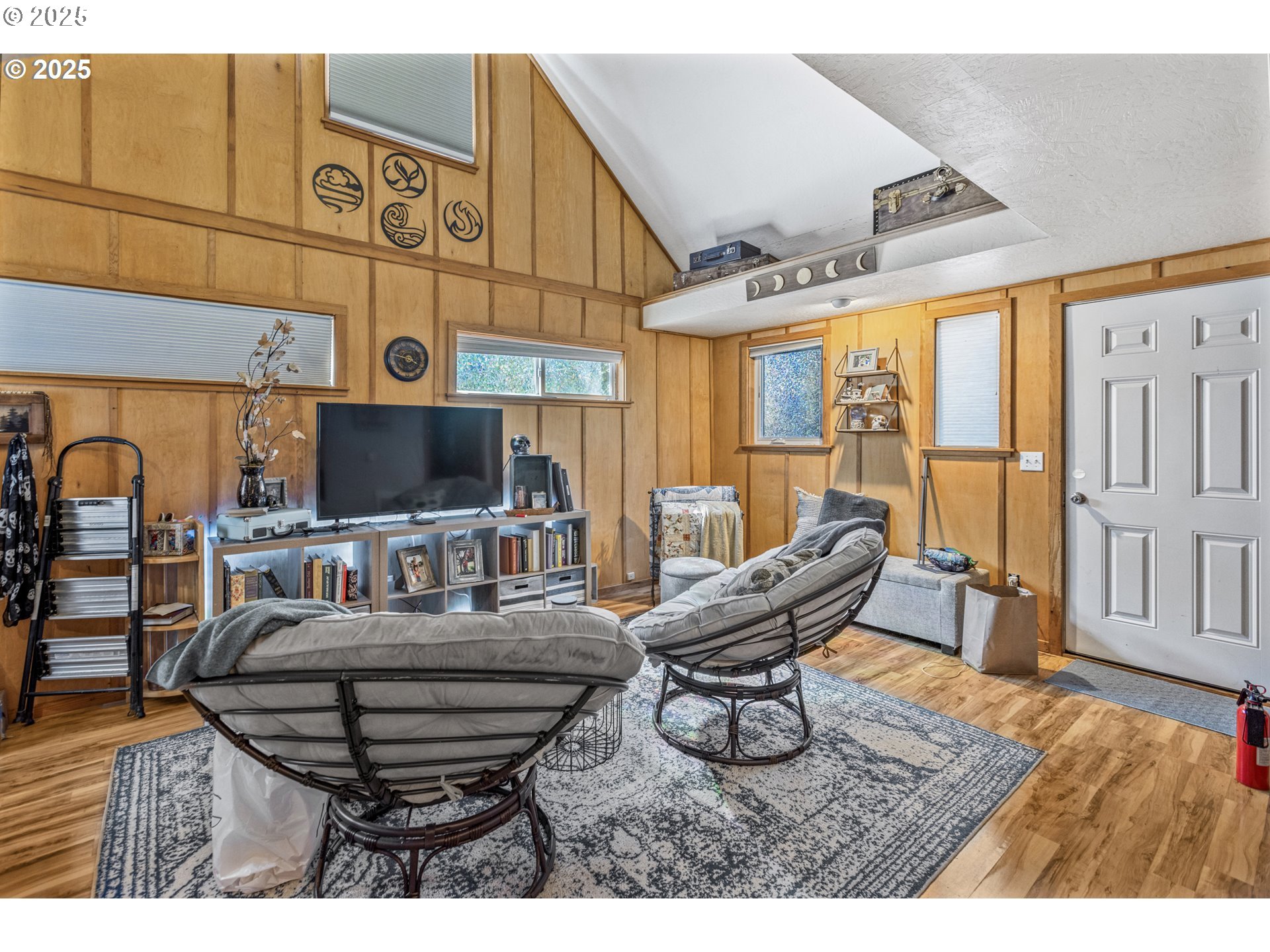 1391 West 5th Avenue Eugene, OR 97402 - Photo 30 of 35 a living room with furniture a flat screen tv and floor to ceiling window