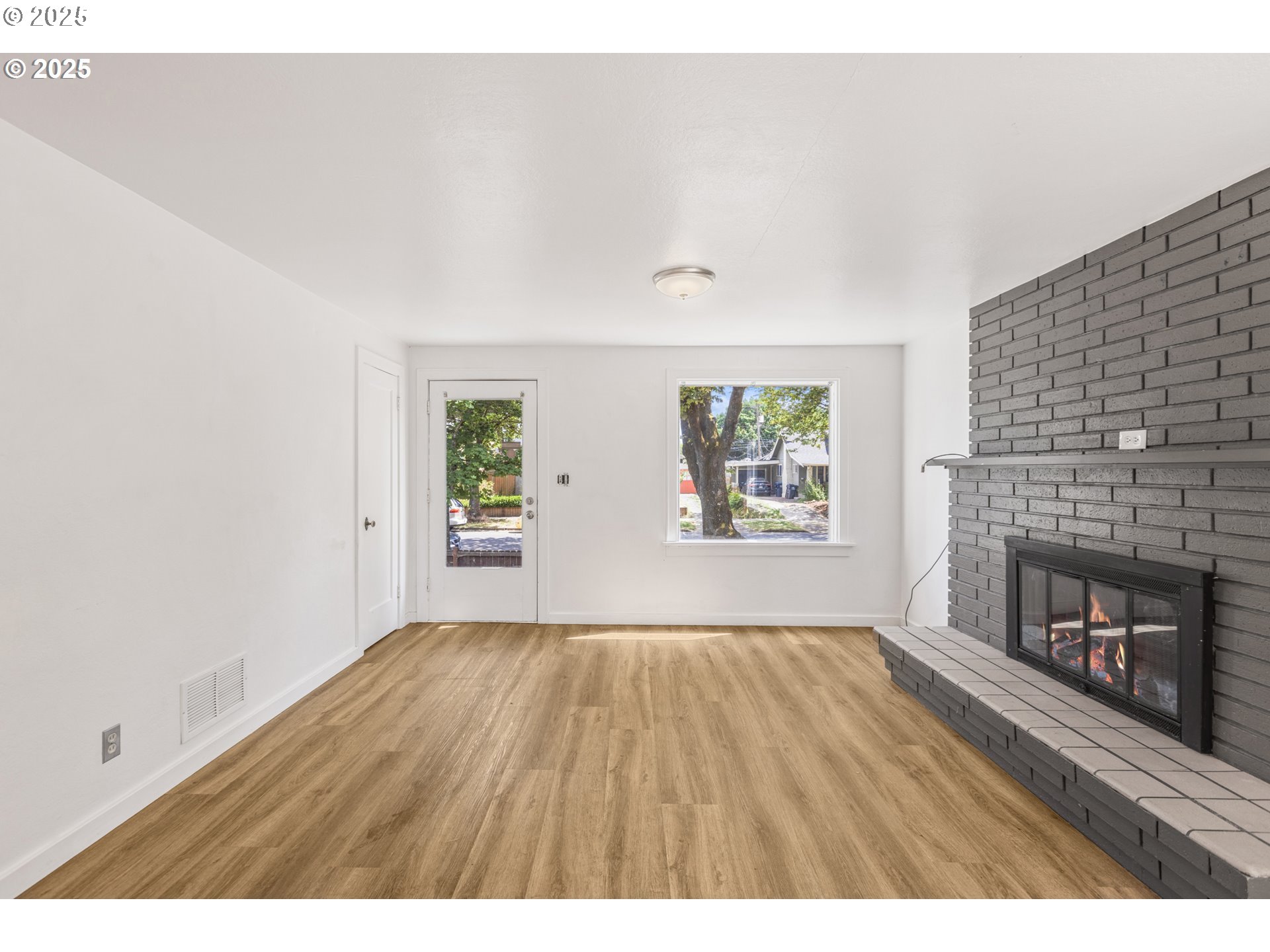 1391 West 5th Avenue Eugene, OR 97402 - Photo 4 of 35 a view of an empty room with window and fire place