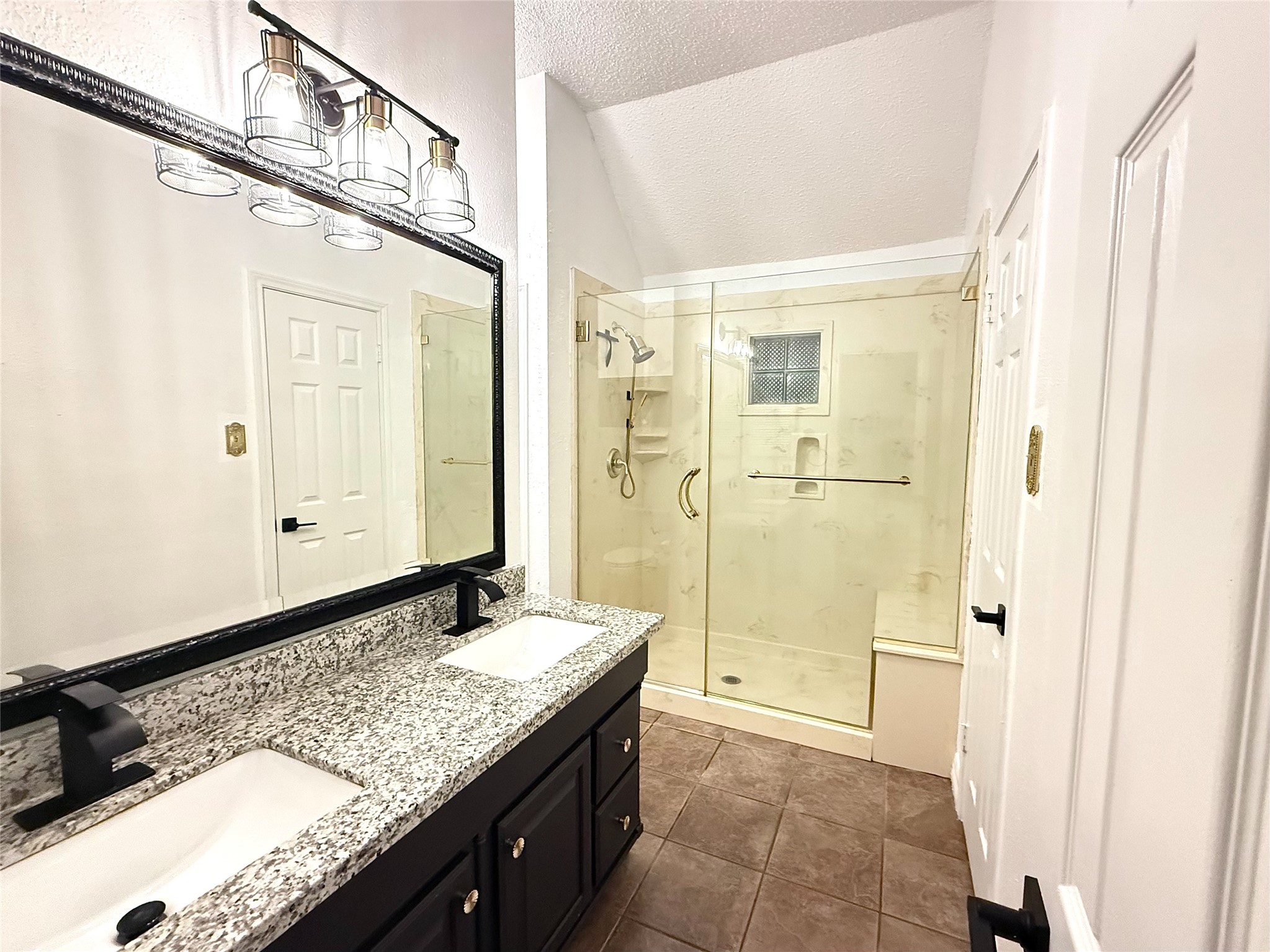 16902 Colony Creek Drive Spring, TX 77379 - Photo 10 of 18 a bathroom with a granite countertop sink mirror and shower