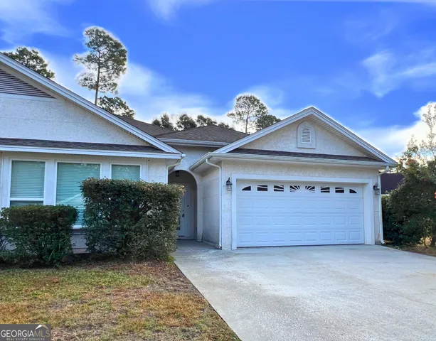 a front view of a house with a garage