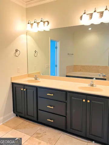 a bathroom with a sink vanity and mirror