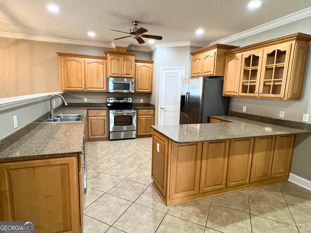 a kitchen with stainless steel appliances granite countertop a stove and a sink