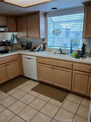 a kitchen with a sink window and cabinets