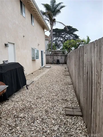 a view of a backyard with wooden fence